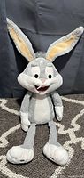 Front view of the Bugs Bunny plush showing facial details, ears, and body including limbs.