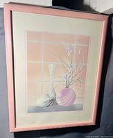 Frontal view of framed wall art showing vases and flowers in pastel colors with pink frame