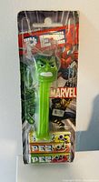 Photo of a sealed Marvel Hulk PEZ dispenser with three packs of PEZ candy included, packaging intact with Marvel branding.