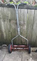Full view of American brand reel push mower showing metal handle and wheel assembly