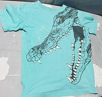 Front view of turquoise boys t-shirt size 6 with crocodile graphic.