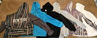 Photo of six women's plus size hoodies in various colors and patterns laid out on a surface.