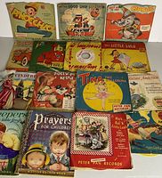 Vintage children's records and books including Peter Pan Records with illustrated sleeves featuring Pinocchio, Circus, Good Ship Lollipop, Tina the Ballerina, and others, plus children's books and prayer book.