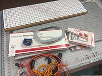 Overview of assortment including quilting mats, Bernina embroidery hoops in boxes, power cords, and accessories.