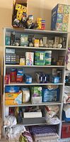 Full shelf showing a variety of cleaning product boxes and light bulb packaging, arranged on shelves.