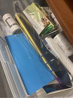 Top drawer shows quilting and sewing kit packs, rolls of paper and supplies inside transparent plastic drawer.