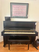 Front view of piano with bench