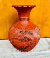 Front view of the terracotta vase showing embossed dragon and flared neck