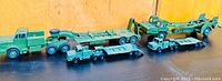 Top view of the four military green transport trucks showing their relative sizes and details.