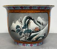 Front view showing detailed mountain and pagoda landscape scene with blossoming trees on orange background with stylized borders.