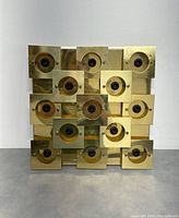 Front view of the gold-tone metal square fixture showing a grid of 16 small square plates with bulb sockets in the center.