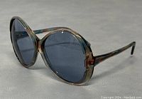 Side angle close-up showing the overall shape and frame color of the sunglasses on a neutral background