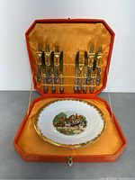 Full case opened showing 10 silver forks and spreaders on the lid and Bavaria porcelain plate inside bottom section.
