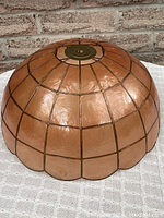 Full side view of the vintage peach Capiz shell lampshade showing the scalloped edges and metal framing.
