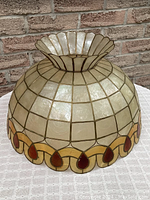 Side view showing scalloped edge teardrop border and fluted crown with Capiz shell panels