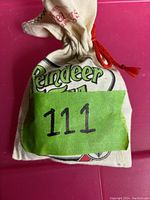 Small fabric bag with number 111 tag containing the jewelry items.