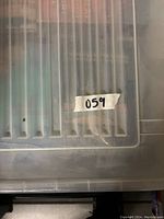 Top view of plastic container with vintage and collectible books inside.