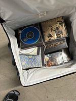 Inside view of luggage showing CDs including Bryan Ferry album and others