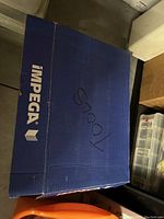 Closed blue Impega branded box containing tools.