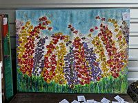 Full view of a wild flowers painting measuring 36x48 inches featuring red, yellow, purple flowers with a blue sky background