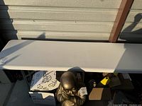 Top view of the white plastic folding table showing surface and edges