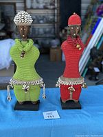 Both Namji Dolls standing side by side on a blue cloth, clear view of full height and detailing.
