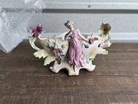 Front view of the vintage bisque ornate princess carriage planter showing detailed floral decoration and princess statue.