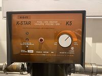 Close-up photo of the K-Star K5-TT pool and spa heater control panel with reset button, indicator light, and temperature dial.