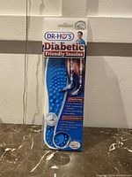 Front view of Dr. Ho's Diabetic Friendly Insoles packaging showing blue textured insole and product features.