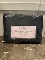 Front view of the new black South Shore Fine Linens 3-piece duvet cover set packaging, showing full/queen size and collection details.