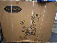 Front of unopened cardboard box showing Cyclace branding and bike illustration