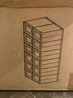 Photo of cardboard box printed with diagram of 12 stacked shoe boxes illustrating the packaging and stacking design.