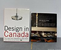 Two hardcover books side by side showing their front covers. Left book titled 'Design in Canada' and right book titled 'The Art of Living According to Joe Beef: A Cookbook of Sorts'.