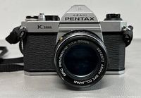 Front view of vintage Asahi Pentax K1000 camera showing the lens and Pentax branding.