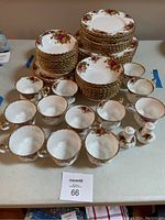 Overview of entire dinnerware set including stacked plates, bowls, cups, saucers, and salt and pepper shakers