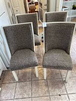 Four chairs grouped together showing overall appearance and condition