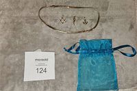 Full lot overview: 17" gold chain, three pendants, blue organza bag