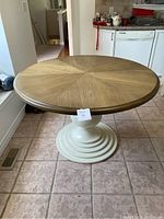 Front view of complete table showing tabletop and pedestal base