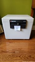 Front view of Sentry 1170 safe showing black front panel with key lock and brand label.