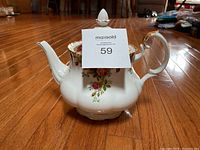 Full view of the Royal Albert Old Country Roses teapot showing the spout, handle, lid with finial and floral design.