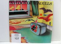 Front cover of A Flock Of Seagulls self-titled album in colorful artwork with seagulls and coastal scene
