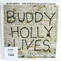 Front cover of Buddy Holly and The Crickets 20 Golden Greats LP showing stylized graffiti text on brick wall background.