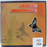 Front view of vinyl LP album Dog And Butterfly by Heart with orange background, butterfly graphic, and stylized text on jacket cover.