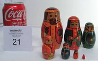 Set of seven Russian nesting dolls displayed with a Coca-Cola can for size reference showing a tallest doll approximately 4.5 inches high.