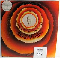 Front cover of the album Songs In The Key Of Life by Stevie Wonder, showing orange-red concentric circles with a small sketch of Stevie Wonder in the center.