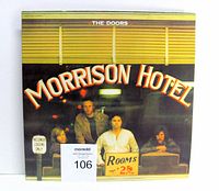 Front cover of The Doors Morrison Hotel vinyl LP with visible gatefold sticker and band members on the cover.