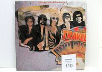 Front view of The Traveling Wilburys album jacket showing wear and bottom right corner damage.
