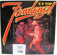 Front view of ZZ Top Fandango album cover with band performing on stage.