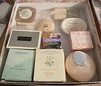 Top-down photo of soap bars, 12 bars visible including various brands and packaging styles