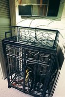 Front and angled view of wrought iron bar cart showing intricate metal gothic design and marble top